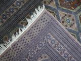 a close up view of a rug with fringes on it