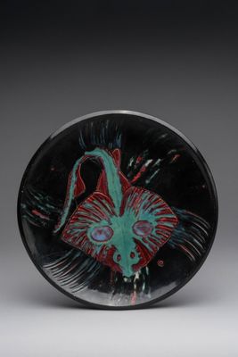 a close up of a glass plate with a fish on it