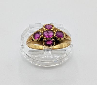 a gold ring with purple stones in it