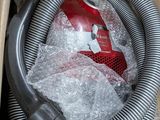 a box with a vacuum and a hose in it
