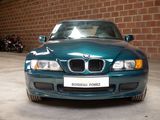 a blue car that is parked in a garage