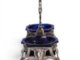 an antique silver and blue glass candle holder on a white background