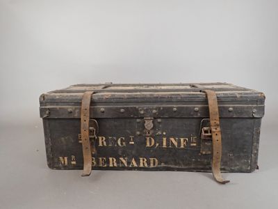 an old trunk is sitting on a table with a sign on it
