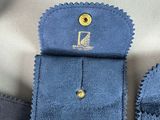 a blue case with a gold button on top of it