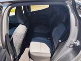 the back seats of a car with the door open and the driver ' s seat down
