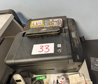 a printer sitting on top of a desk next to a printer