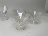 several empty wine glasses sitting on top of a white table