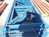 a long blue metal structure sitting in the middle of a lot
