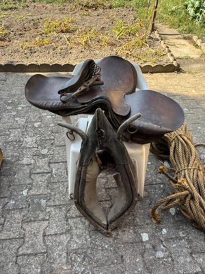 a pile of shoes and a rope on the ground