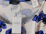 a close up of a blue and white dress on a hanger