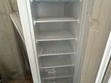 a white refrigerator with a door open in a room
