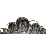 a silver vase that has a wave design on it