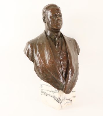 statue of a bust of a man in a suit on a marble base