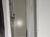 a bathroom with a toilet and a shower in it