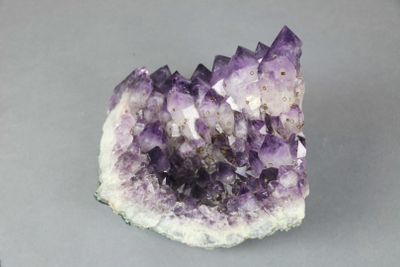a close up of a piece of amethorate on a gray surface