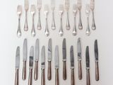 a lot of forks and knives on the table