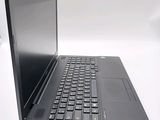 a laptop with a black keyboard on a white surface