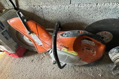 two chainsaws that are laying on the ground