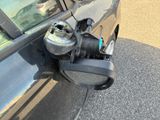 a car with a gas can attached to it ' s side mirror