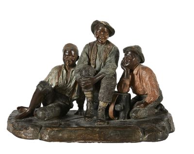 statue en bronze représentant trois hommes assis sur un rocher en compagnie d'un chien