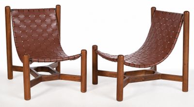 pair of brown leather lounge chairs with wooden legs on a white background