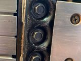 a close up of a metal object with screws on it