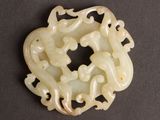 an image of a white jade pendant with a dragon design on it