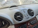 a car dashboard with a clock and air vents