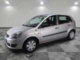 a picture of a small silver car parked in a garage