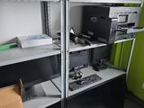 une pièce remplie de cartons, avec un ordinateur posé sur une étagère