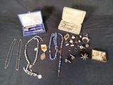 a lot of jewelry that is laying out on the table