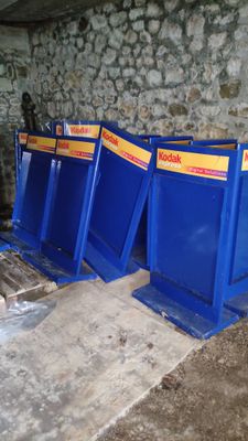 three blue bins that are sitting on the ground