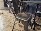 tables and chairs in a restaurant with a dog sleeping on the floor
