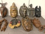 many different types of african masks displayed on a table