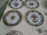 six plates on a table with a spoon and spoon rest