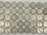 a pile of silver coins sitting on top of a white surface