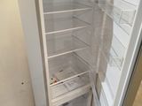 a white refrigerator with its door open in a room