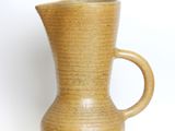 a brown vase with a handle on a white background
