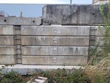 a pile of concrete blocks next to a yellow fire hydrant