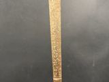 an old gold sword with a long blade on a black background
