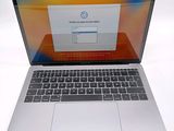 a laptop that is open on a white surface