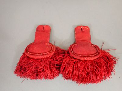 pair of red tassels on a white surface