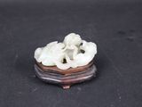 chinese carved jade figurine of two elephants on a wooden stand