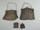 two brown purses and a pair of gloves on a white surface