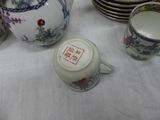 a white table topped with cups and saucers and plates