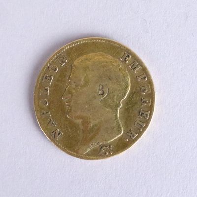 a gold coin with a picture of a man ' s face on it