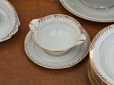 a lot of plates and cups sitting on a table