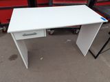 a white desk with a drawer on top of it next to a chair