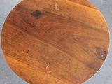 an image of a round table with a wooden top on a tile floor