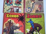 four comics are on display on a table in front of a white background